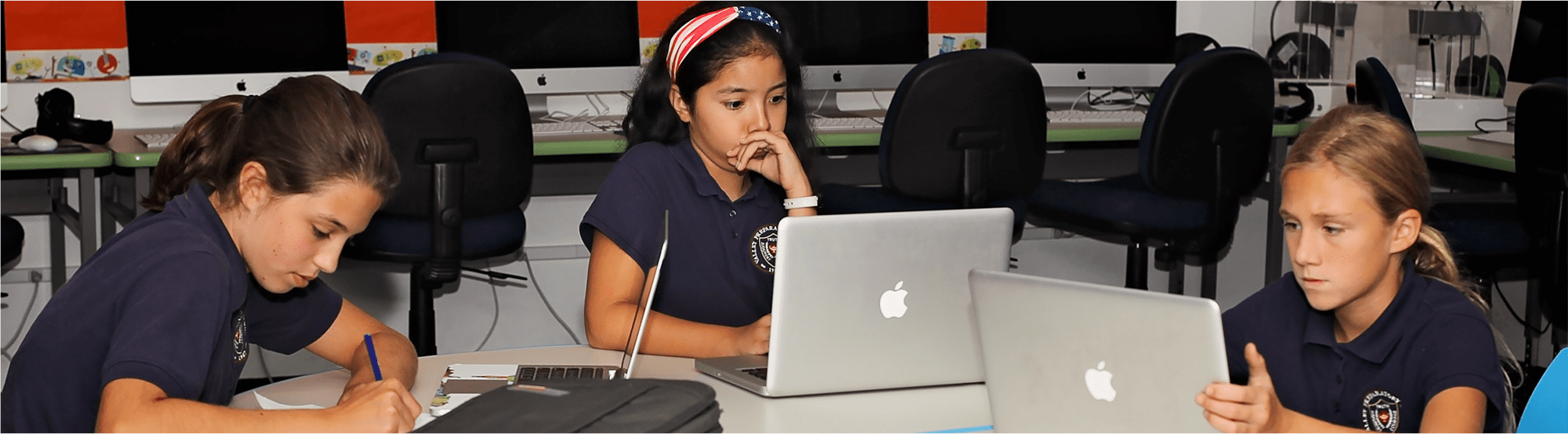 Female students use laptops in class